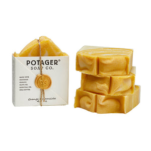 Potager Soap Co. Orange Creamsicle artisan soap bars with a white paper wrapper and a gold wax seal.