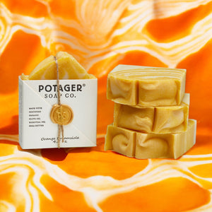 Potager Soap Co. Orange Creamsicle artisan soap bars with marbled orange and white texture on a vibrant orange background