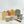 Potager Soap Co. Organic Botanical Shower Starter Kit with four soap bars, shower steamers, wooden dish, and scrub bag.