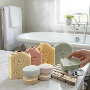 Potager Soap Co. organic botanical shower kit with soap bars, shower steamers, wooden soap dish, and scrubby bag.