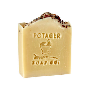 Potager Soap Co. Secret Garden organic castile soap bar with dried flower petals and embossed mortar and pestle logo.