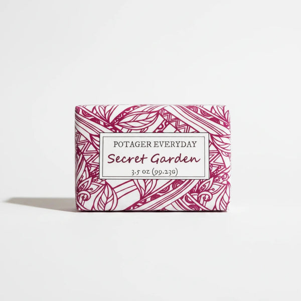 Potager Soap Co. Secret Garden bar soap in white paper packaging with pink botanical illustrations.