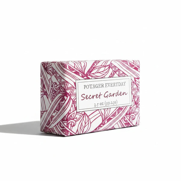 Potager Soap Co. Secret Garden bar soap in white packaging with pink botanical illustrations and elegant typography.