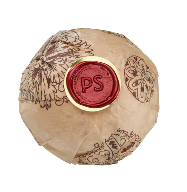 Potager Soap Co. Secret Garden bath bomb wrapped in floral paper with a red wax seal featuring PS initials.
