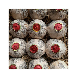 Potager Soap Co. Secret Garden bath bombs wrapped in patterned paper with red wax PS seals in a gift box