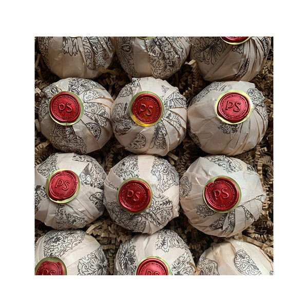 Potager Soap Co. Secret Garden bath bombs wrapped in patterned paper with red wax PS seals in a gift box