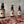 Three Potager Soap Co. Secret Garden room and linen spray bottles on a wooden surface with scattered dried flower petals.