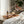 Potager Soap Co. Secret Garden organic room and linen spray in amber glass bottles on a wooden tray with flower petals.