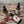 Three Potager Soap Co. Secret Garden organic room and linen spray bottles in amber glass on a rustic wooden surface.