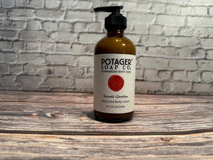 Potager Soap Co. Secret Garden hand and body lotion in an amber glass bottle with a black pump dispenser.