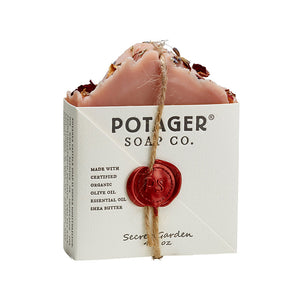 Potager Soap Co. Secret Garden organic castile soap bar topped with dried flower petals and a signature wax seal.