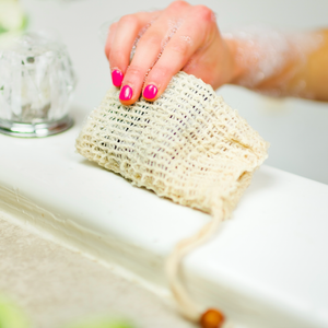 Potager Soap Co. natural sisal exfoliating soap saver bag being used with a bar of soap to create a rich lather