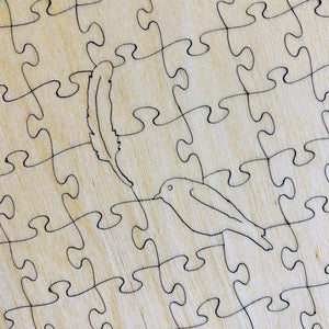 Potager Soap Co. wooden jigsaw puzzle featuring laser-cut whimsy pieces shaped like a bird and a feather