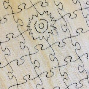 Potager Soap Co. wooden jigsaw puzzle featuring a detailed sunflower and butterfly design on natural wood grain.